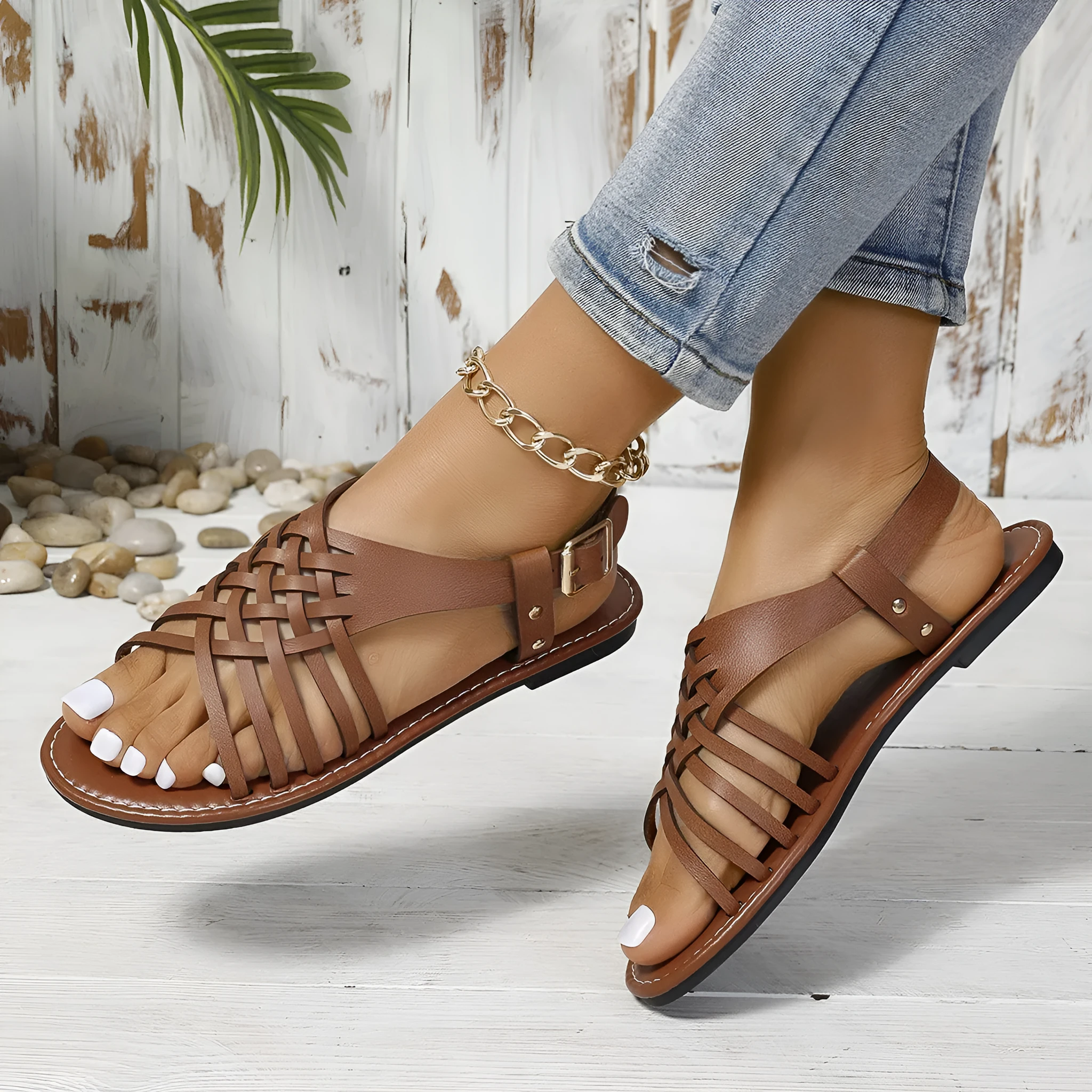 Flat buckle open toe Roman style beach slippers in black with cross straps and hollow out sole