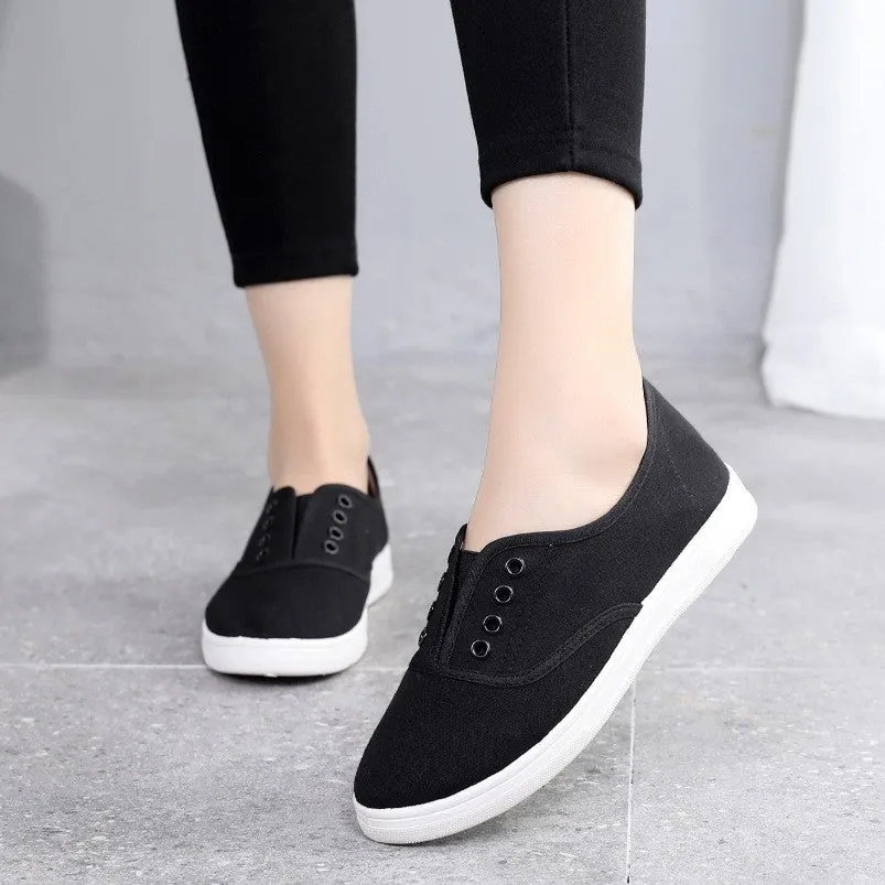 A pair of low-top canvas casual shoes in black with a flat plastic sole
