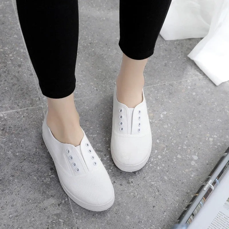 A pair of low-top canvas casual shoes in black with a flat plastic sole