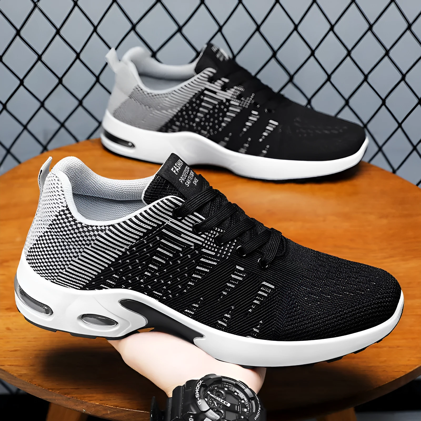 Men's low-top black and gray Flyknit mesh casual sneakers with lace-up front and round toe.
