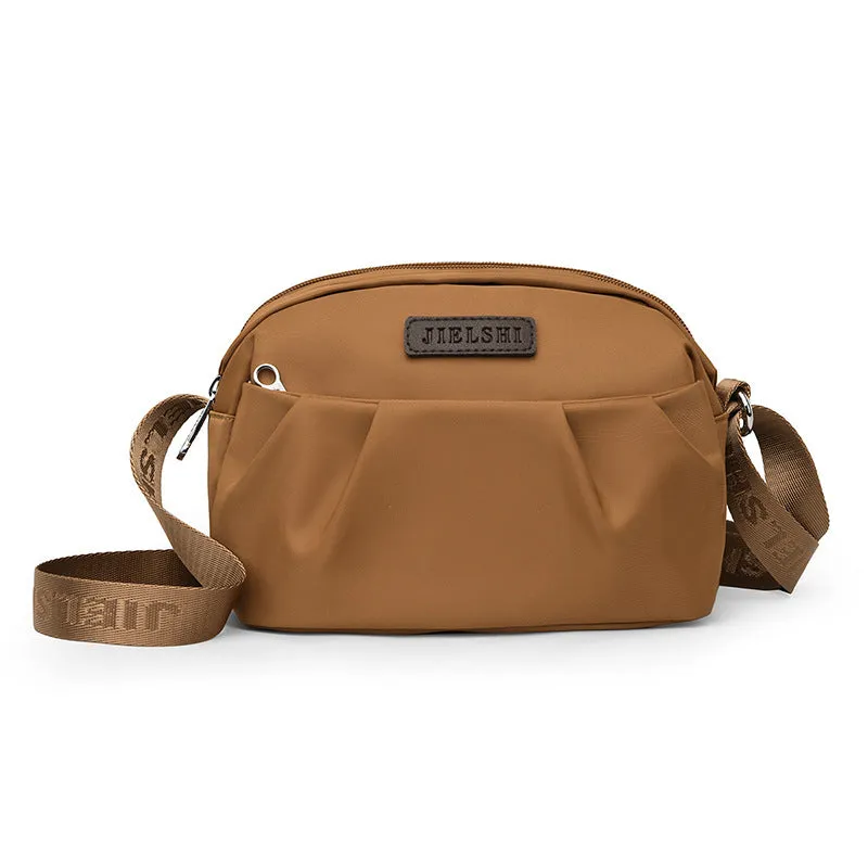 Pleated Oxford cloth crossbody messenger bag in a horizontal square shape with a phone compartment.
