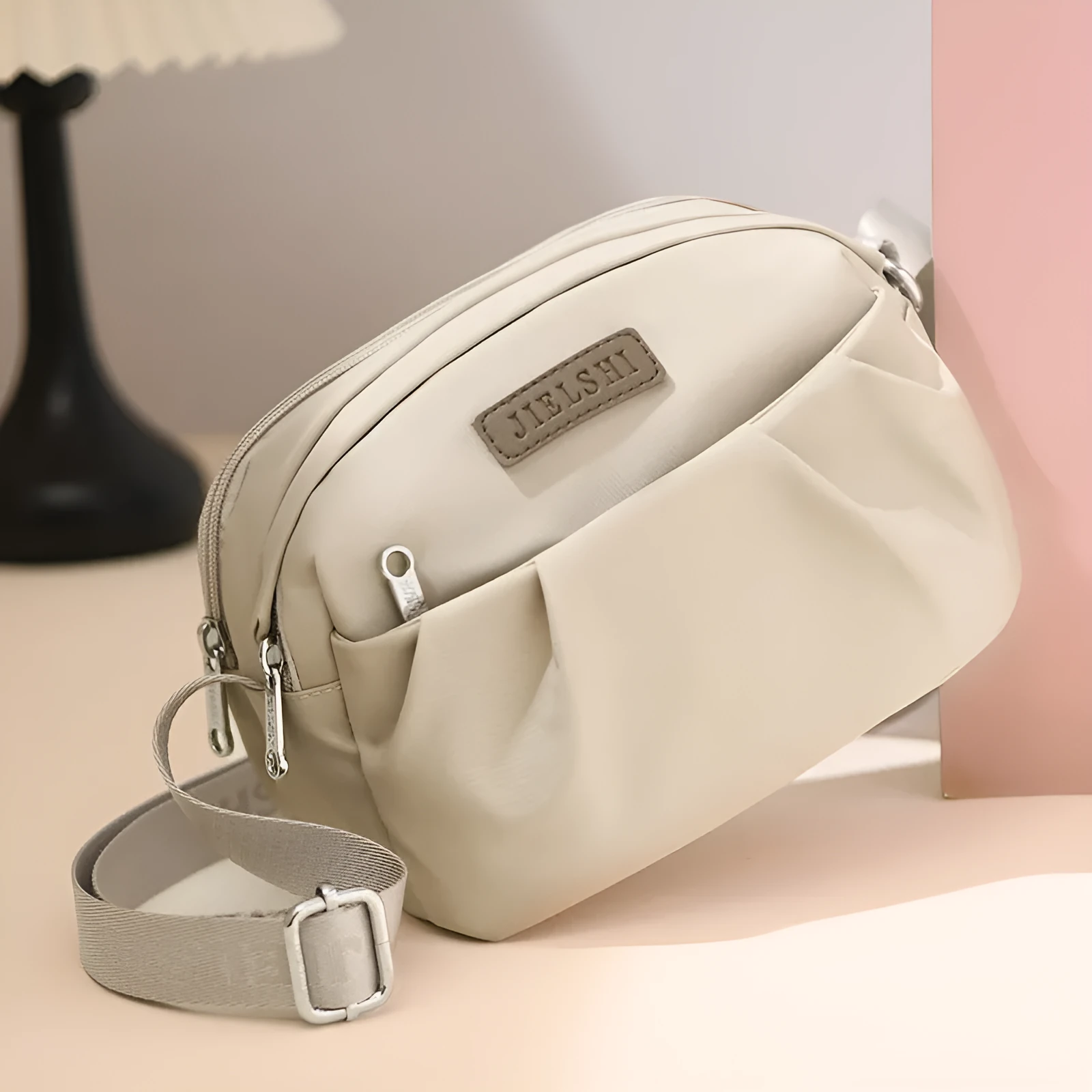 Pleated Oxford cloth crossbody messenger bag in a horizontal square shape with a phone compartment.