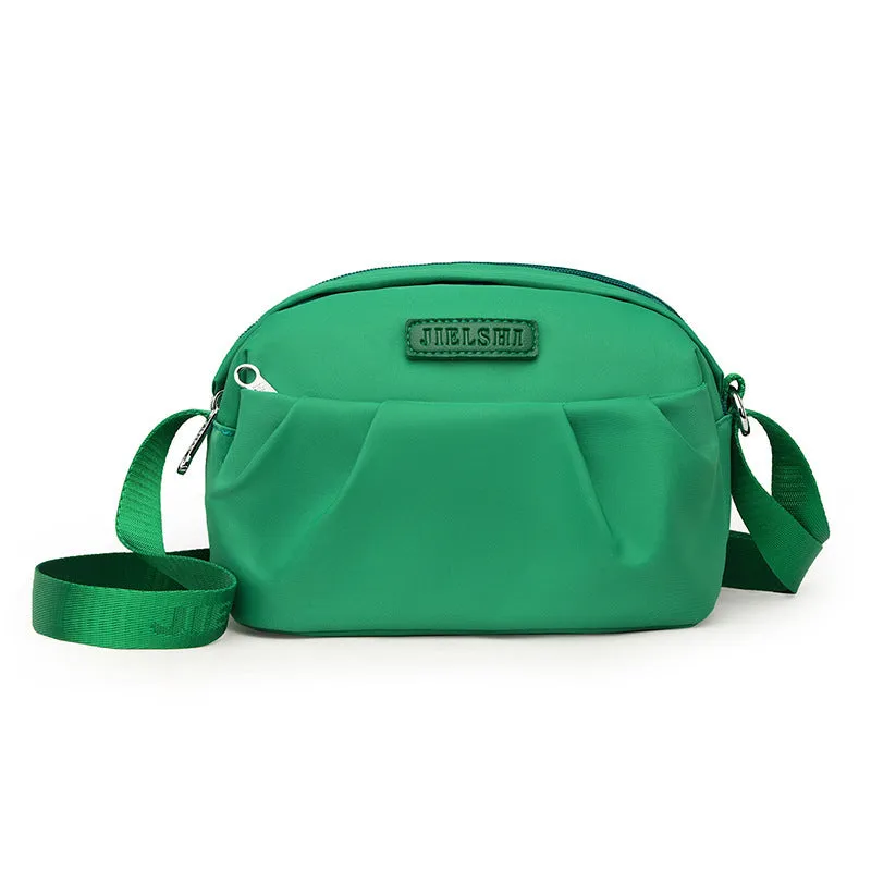 Pleated Oxford cloth crossbody messenger bag in a horizontal square shape with a phone compartment.