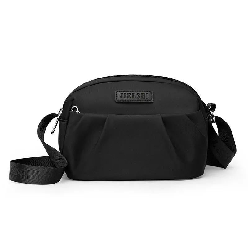 Pleated Oxford cloth crossbody messenger bag in a horizontal square shape with a phone compartment.