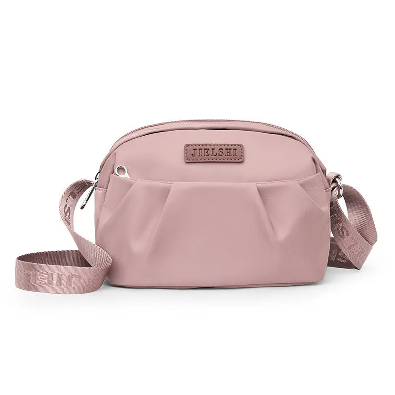 Pleated Oxford cloth crossbody messenger bag in a horizontal square shape with a phone compartment.