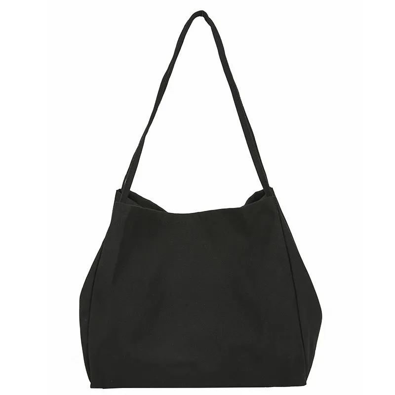 Women's black canvas shopping handbag with double shoulder straps showing internal mobile phone pocket