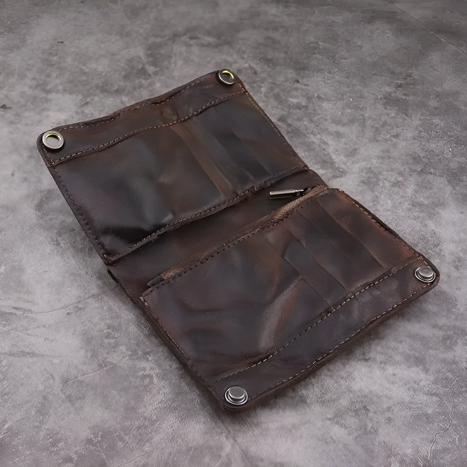 Men's brown leather bifold wallet open showing multiple card slots and coin pocket