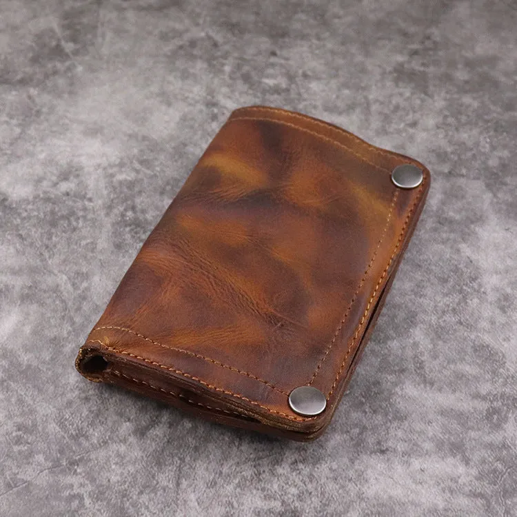 Men's brown leather bifold wallet open showing multiple card slots and coin pocket
