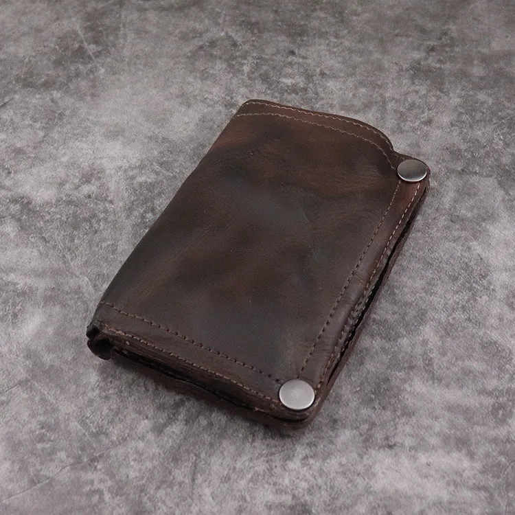 Men's brown leather bifold wallet open showing multiple card slots and coin pocket