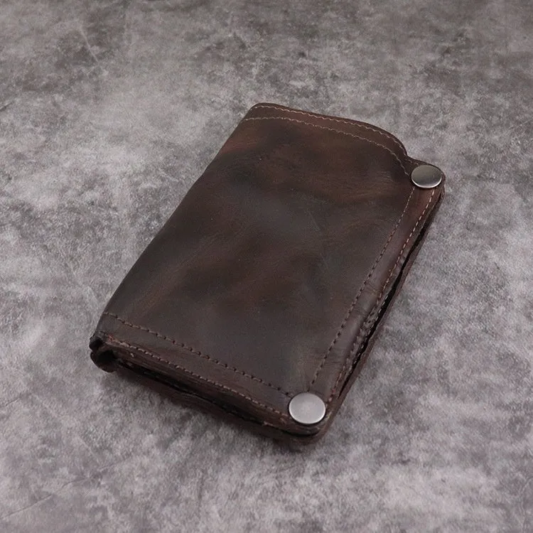 Men's brown leather bifold wallet open showing multiple card slots and coin pocket