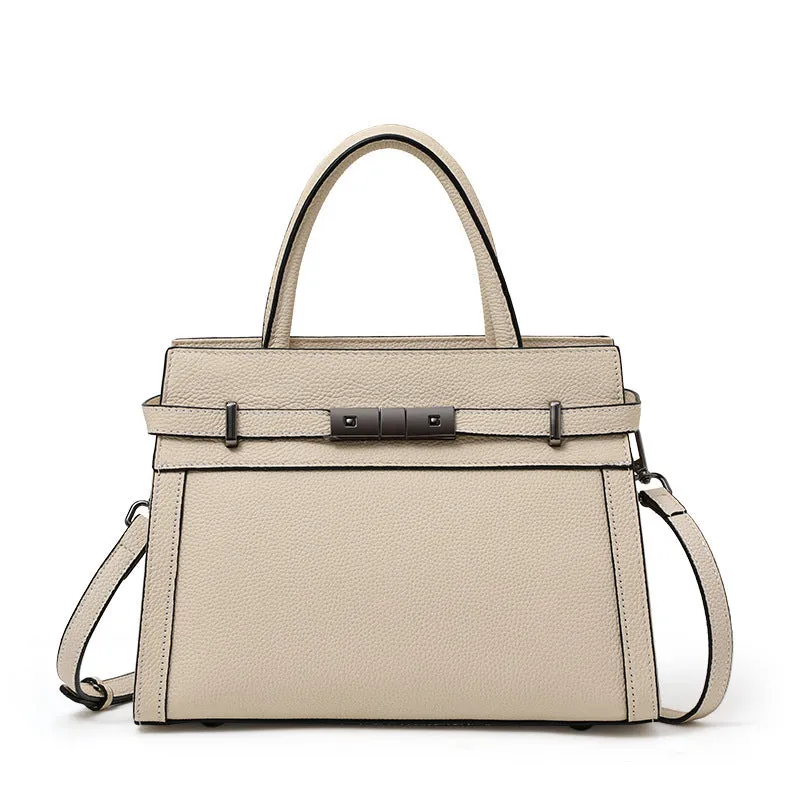 Women's black genuine leather crossbody clamshell handbag with multiple internal zip pockets.