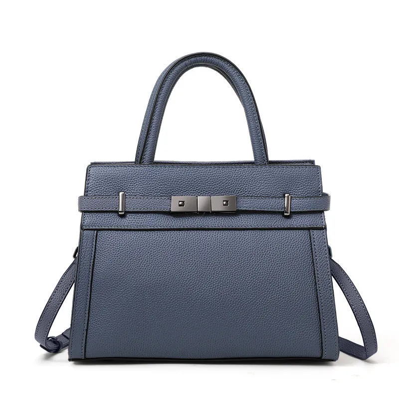 Women's black genuine leather crossbody clamshell handbag with multiple internal zip pockets.
