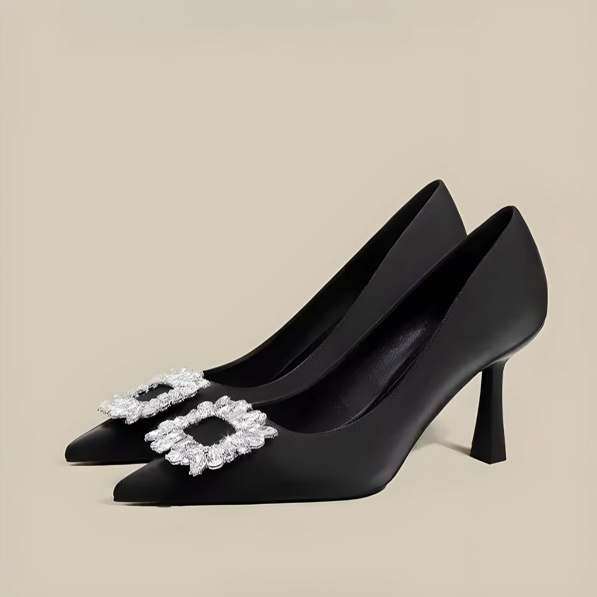 Women's creamy-white pointed toe stiletto high heels with a mid-height heel on a plain background.
