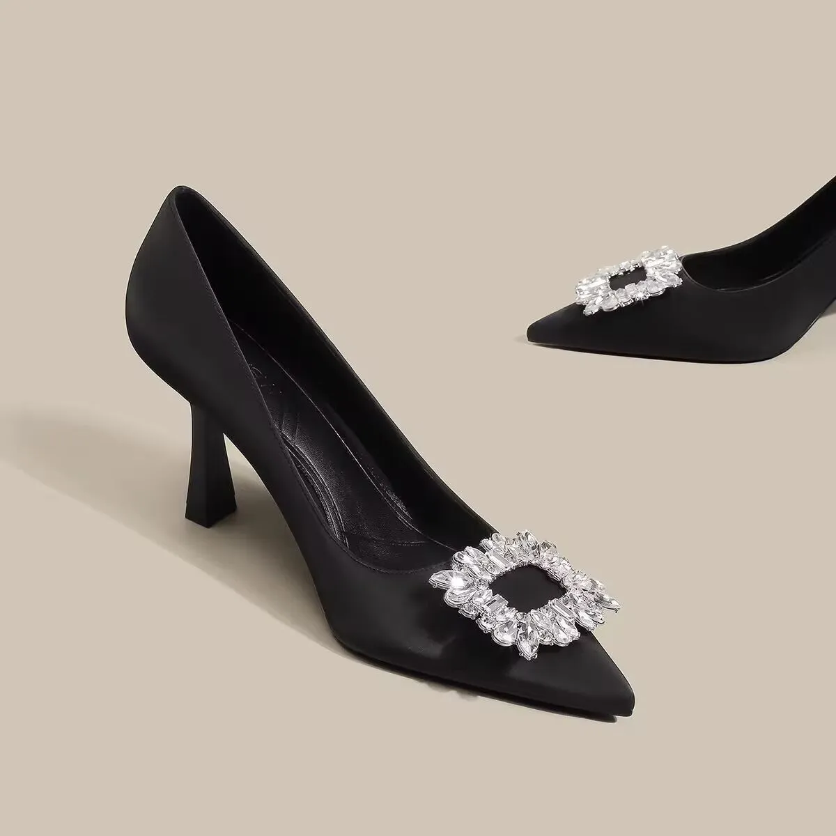Women's creamy-white pointed toe stiletto high heels with a mid-height heel on a plain background.