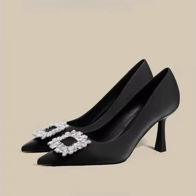 Women's creamy-white pointed toe stiletto high heels with a mid-height heel on a plain background.