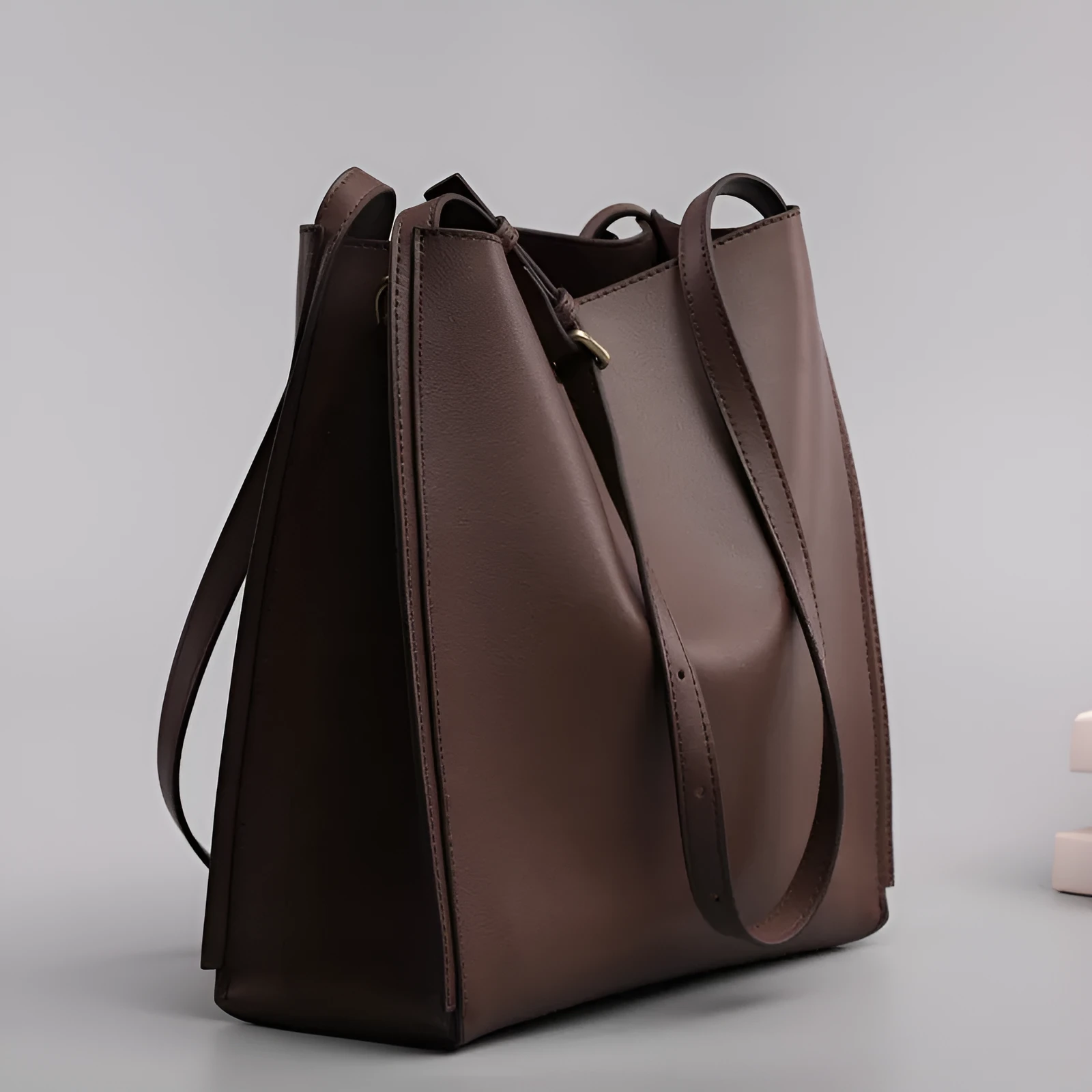 Brown genuine leather retro-style women's commuter bag with dual shoulder straps and external slit pocket.