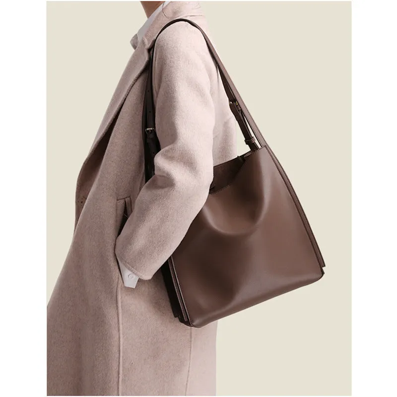 Brown genuine leather retro-style women's commuter bag with dual shoulder straps and external slit pocket.