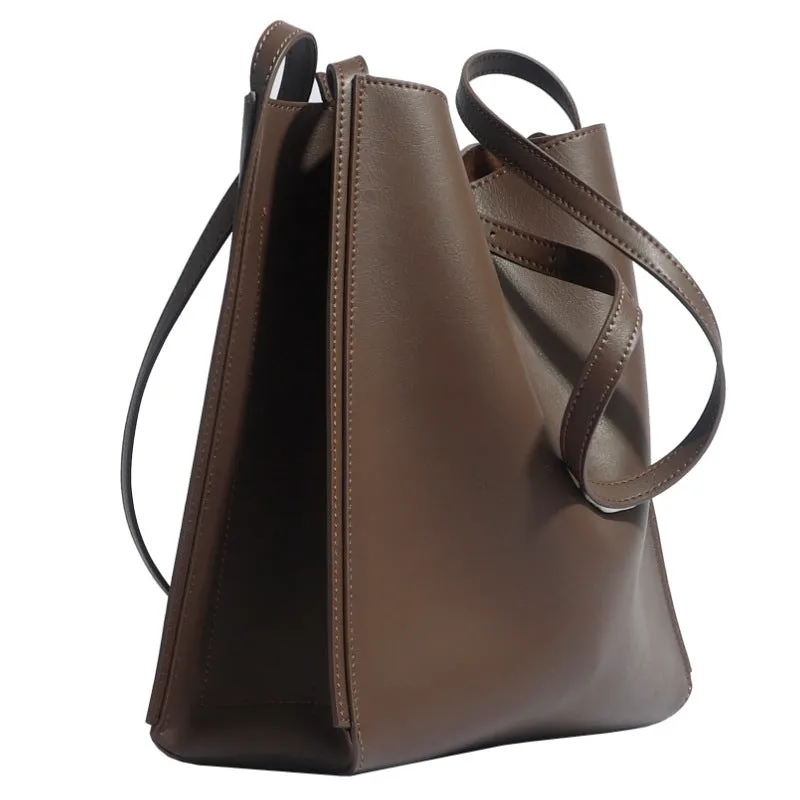 Brown genuine leather retro-style women's commuter bag with dual shoulder straps and external slit pocket.