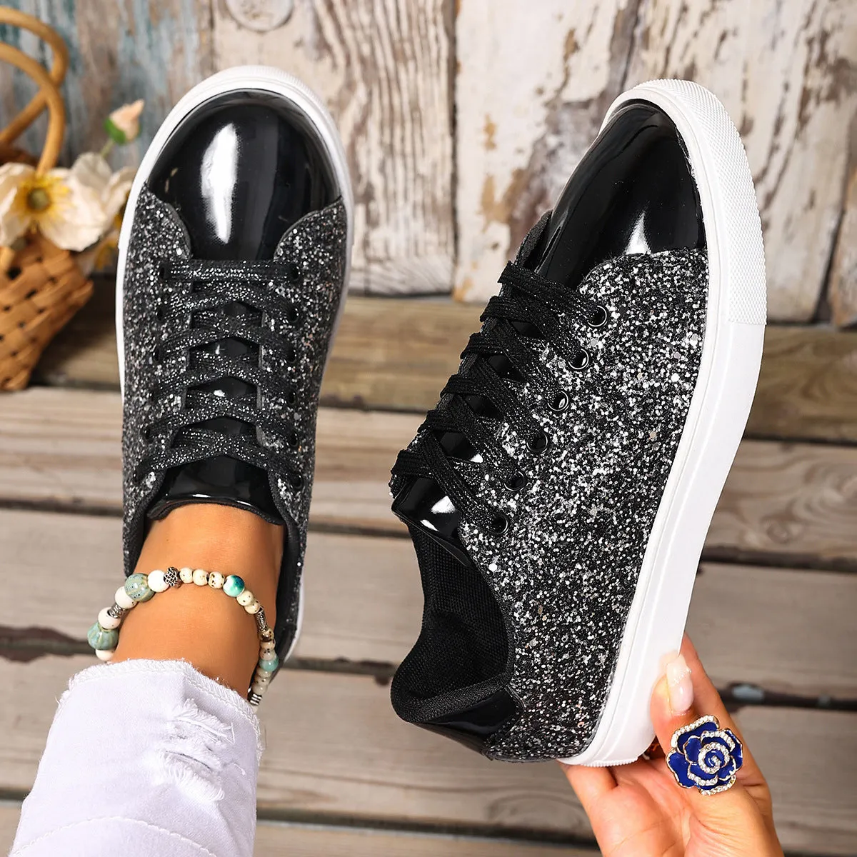 Women's plus size black sequin lace-up flat board shoes on a plain background