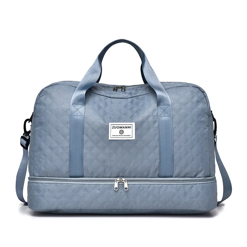 Large oxford cloth travel bag in a solid colour with visible sewing thread details, shown with the main compartment open.