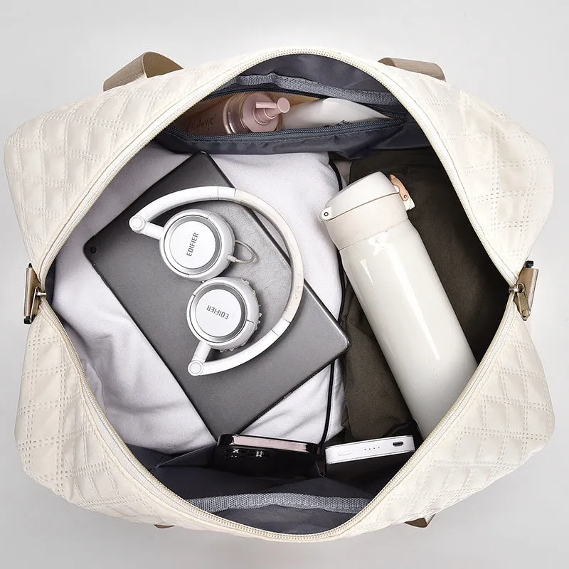 Large oxford cloth travel bag in a solid colour with visible sewing thread details, shown with the main compartment open.