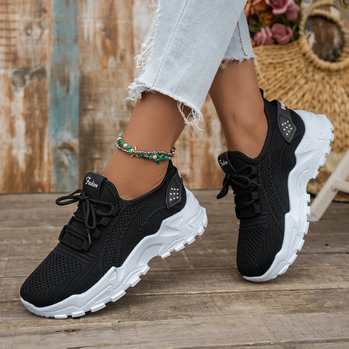 Women's white Flyknit mesh casual sports shoes with flat heel and lace-up front on a plain background.