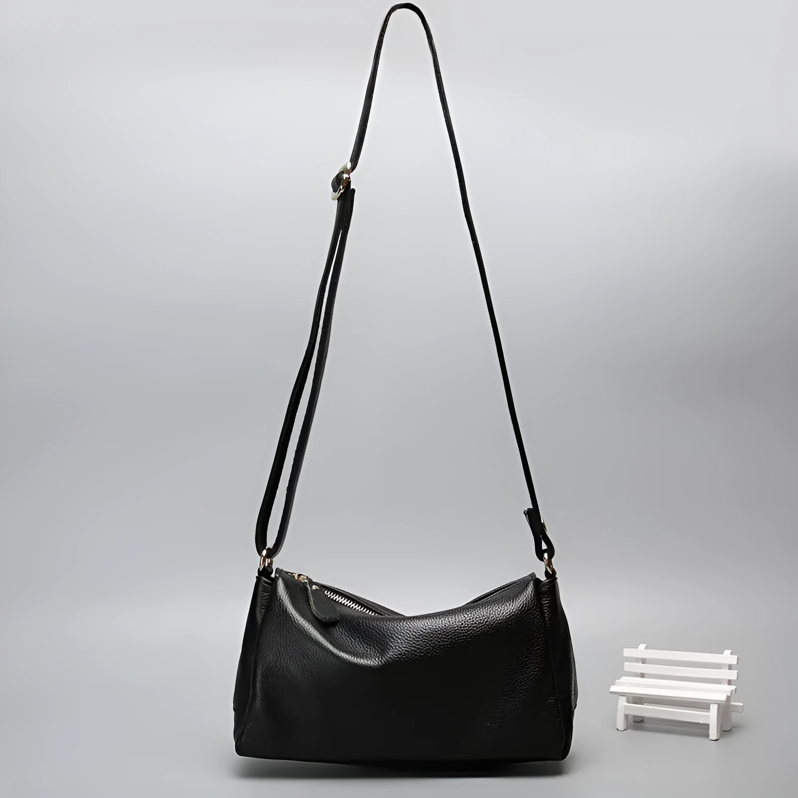 A soft genuine leather women's crossbody bag in a horizontal square shape, shown in one of four available colours.