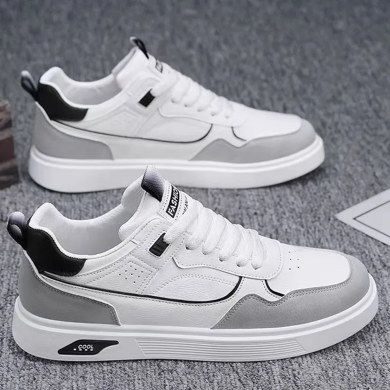 Men's low-top canvas shoes in grey with leather stitching detail on a white background