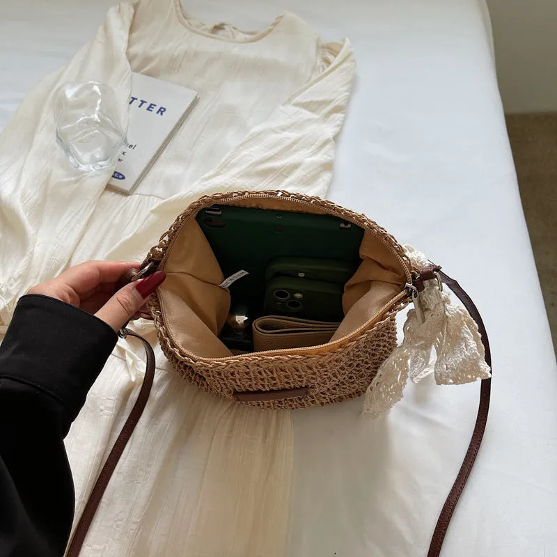 Women's woven straw shoulder messenger bag in khaki with zip pocket and single strap.