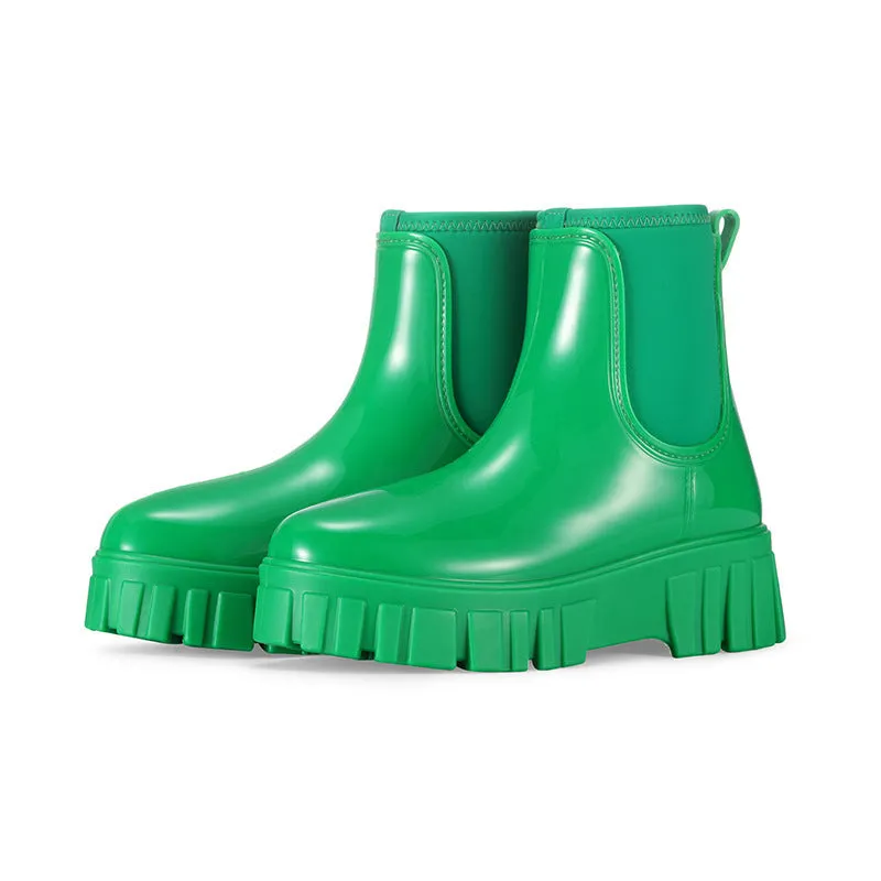 Creamy-white low tube PVC rain boots with a flat heel and non-slip sole on a plain background.