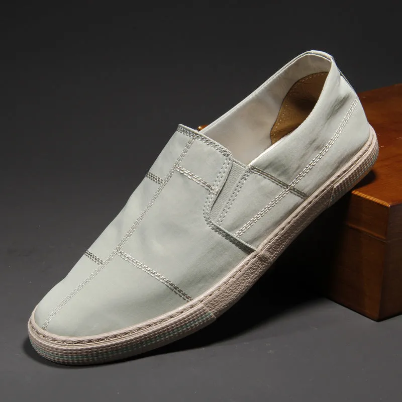 Men's slip-on canvas shoes in various colours showing round toe and low-top design