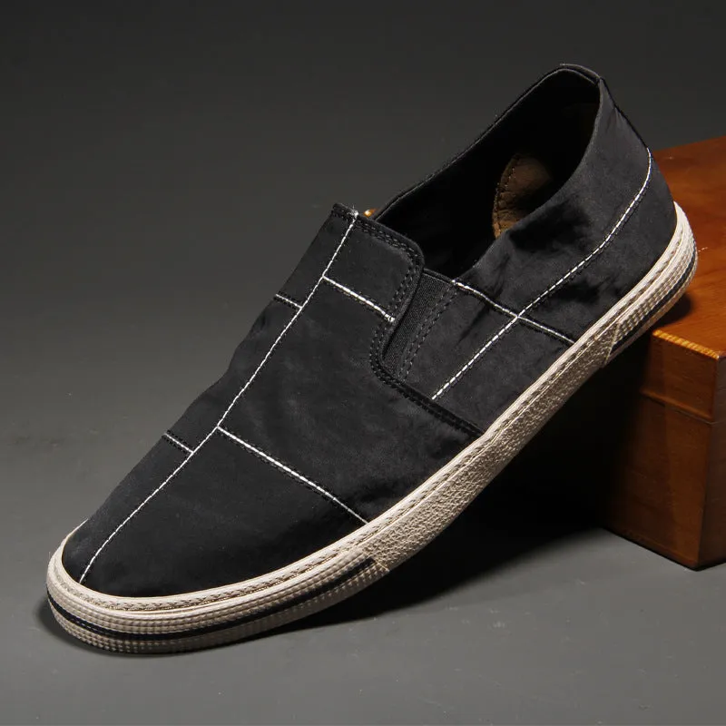 Men's slip-on canvas shoes in various colours showing round toe and low-top design