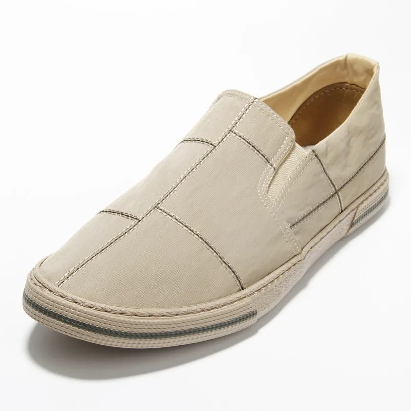 Men's slip-on canvas shoes in various colours showing round toe and low-top design