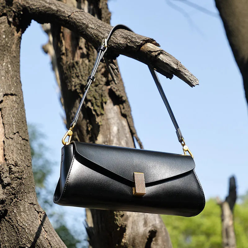 Women's leather cross-body bag with clamshell opening in milky white colour showing pillow-shaped design