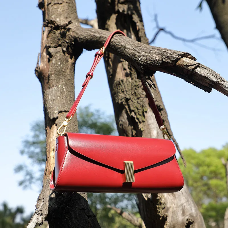 Women's leather cross-body bag with clamshell opening in milky white colour showing pillow-shaped design