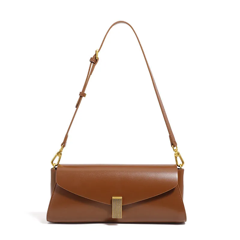 Women's leather cross-body bag with clamshell opening in milky white colour showing pillow-shaped design