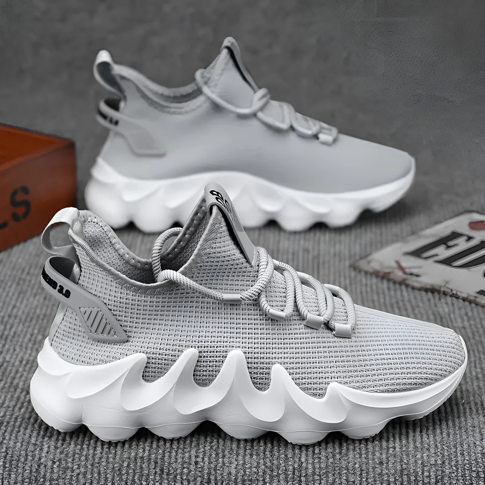 Men's low-top sock-like sports shoes in grey with a round toe, flat heel, and lace-up front.