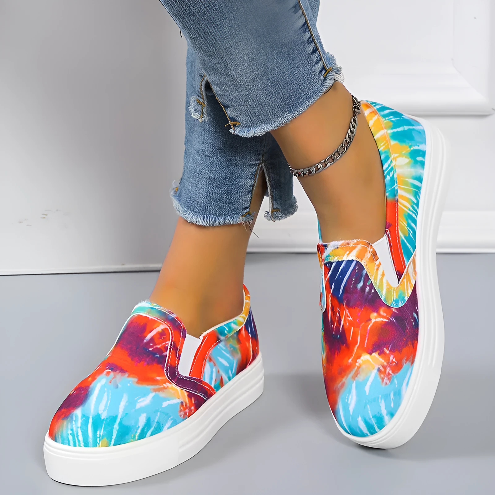 Women's low-top canvas slip-on shoes in colour matching pattern with rubber sole.