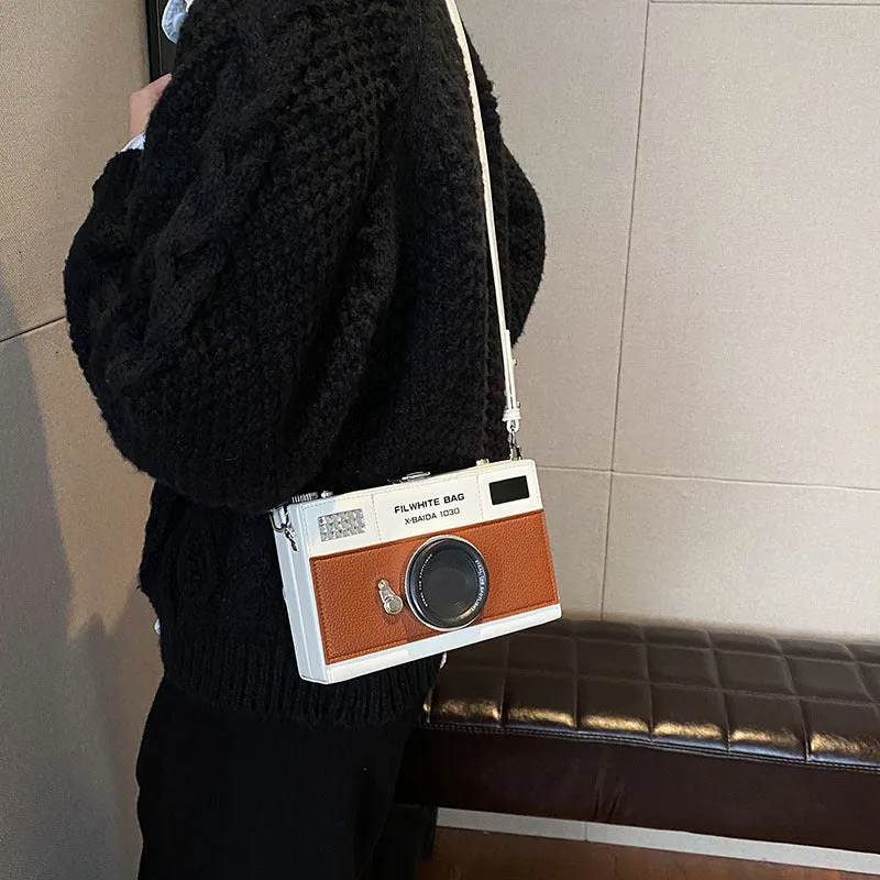 Soft black PU leather mini crossbody bag with a silver chain strap in a horizontal square shape.