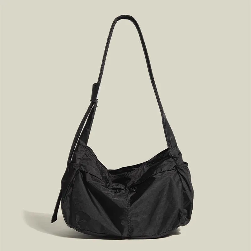 Black nylon waterproof sports style messenger bag with horizontal square design and shoulder strap
