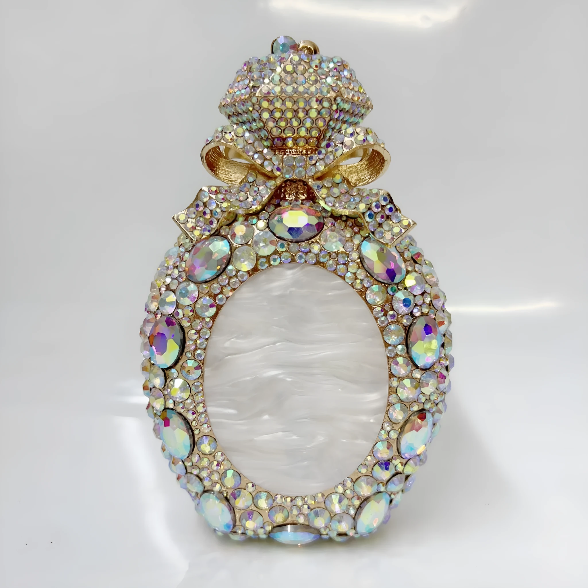 Golden white hard alloy clutch bag with full diamond decoration and a three-dimensional pocket shape.