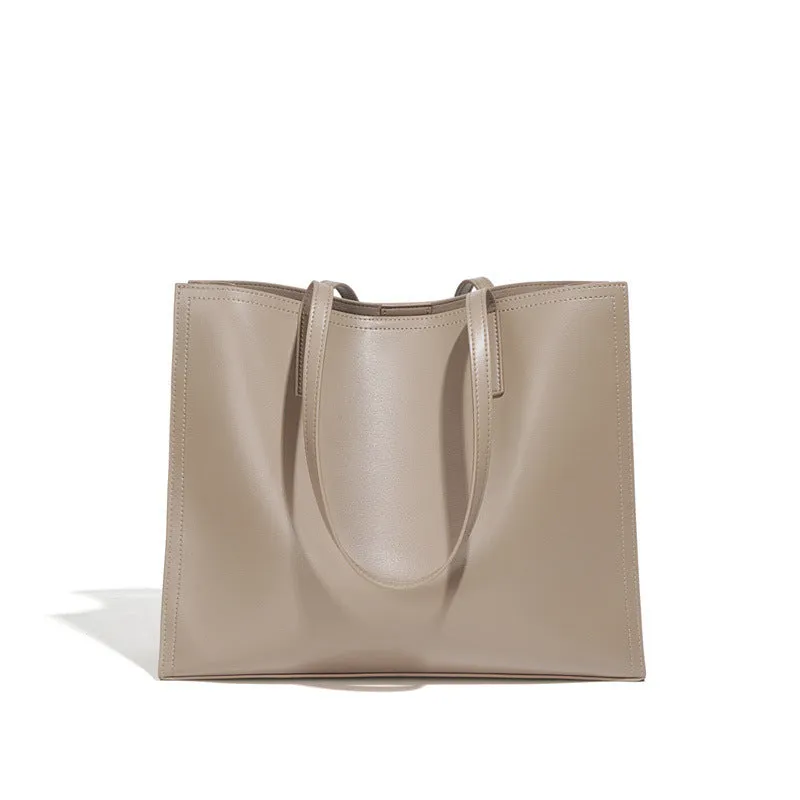Women's brown genuine leather one-shoulder handbag with visible stitching and a single strap.