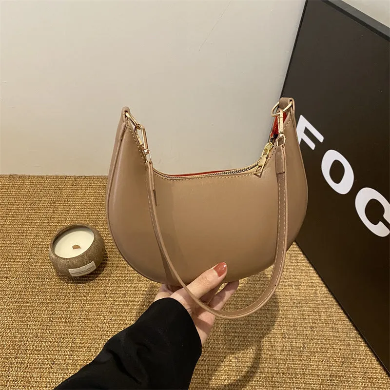 Round green one-shoulder underarm bag with visible sewing lines and sandwich-style compartments