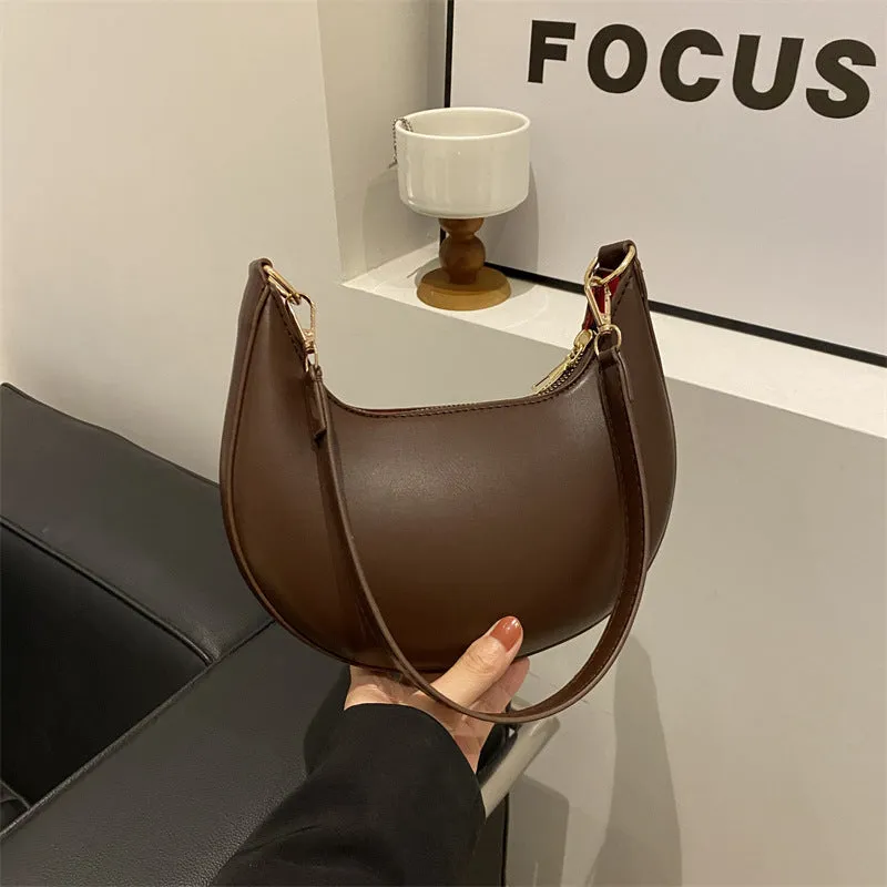 Round green one-shoulder underarm bag with visible sewing lines and sandwich-style compartments