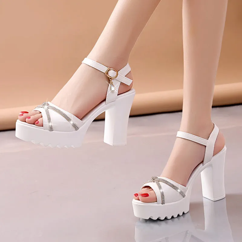 Women's black strappy high heel sandals with a platform wedge and block heel on a white background.