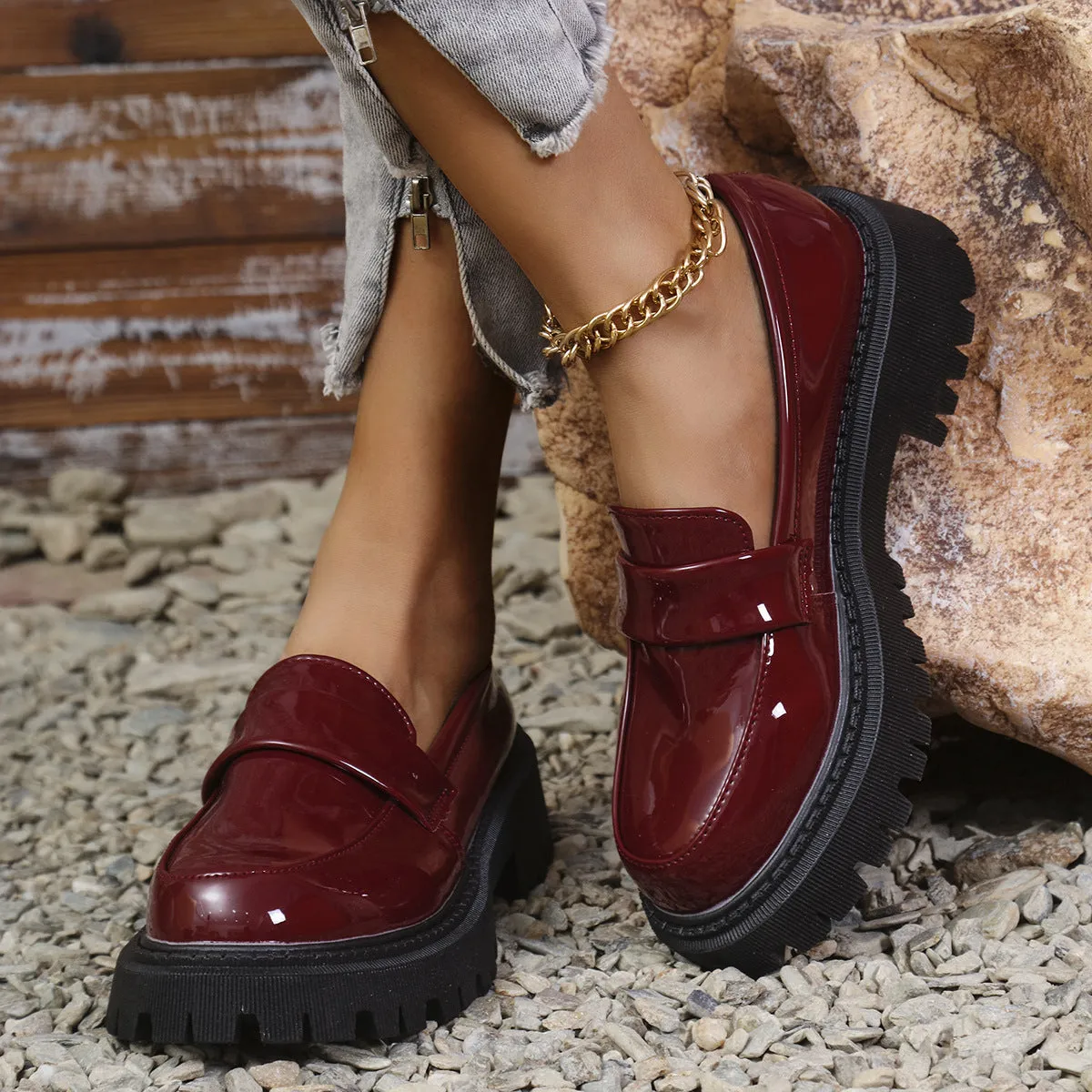 Plus size women's black slip-on loafers with a chunky platform heel and rubber sole.