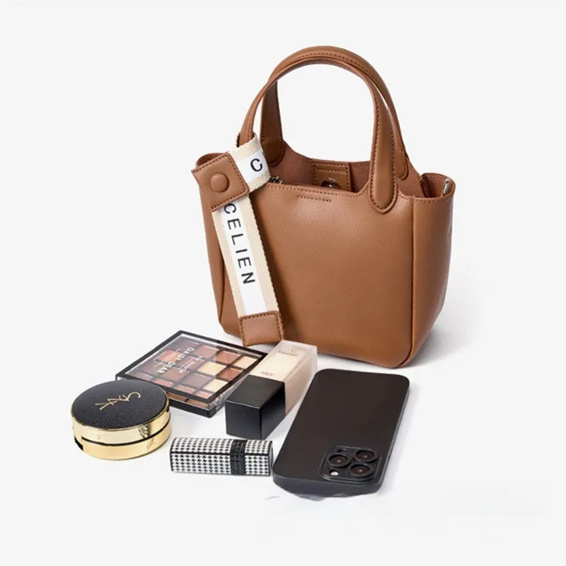 Brown cattlehide leather cross body bucket bag with square vertical design and slit pocket