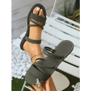 Women's flat sandals with cross strap and flip-toe buckle in black, brown, or green colours