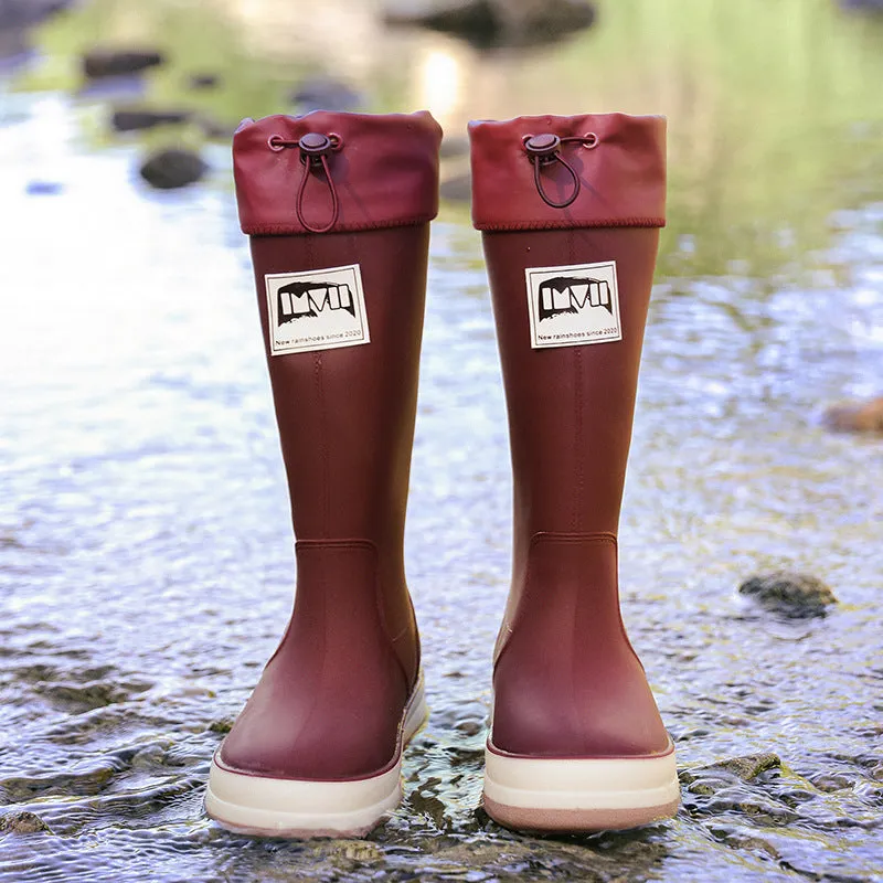 Solid colour high tube PVC rain boot in beige, shown on a white background.