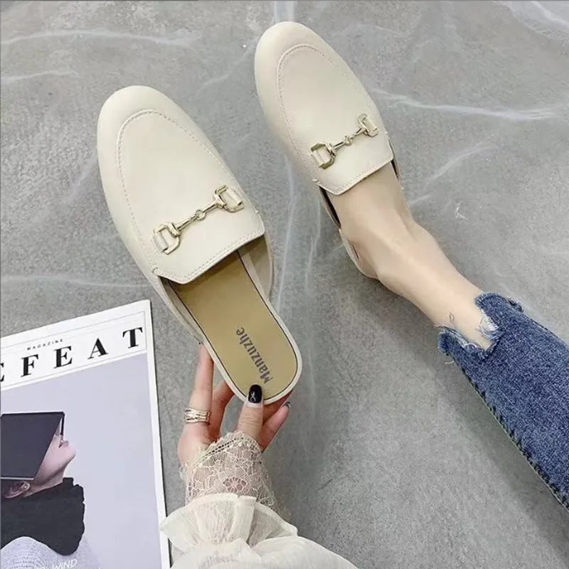Women's closed toe PVC half slipper in milky white with a double buckle fastening.